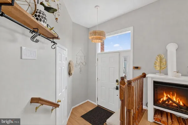 a view of hallway with stairs and wooden floor