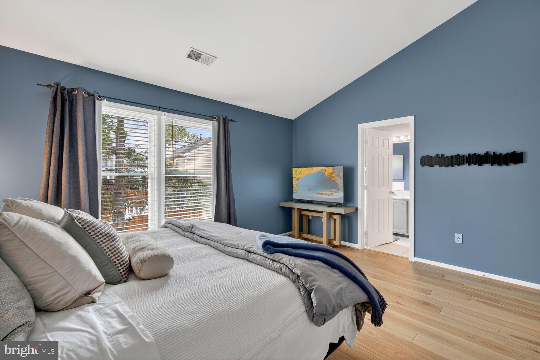 8713 Wadebrook Terrace Springfield, VA 22153 - Photo 10 of 21 a bedroom with a bed and a flat tv screen on dresser