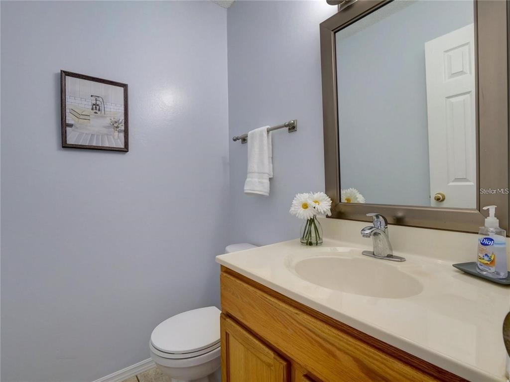 351 Monarco Avenue Deltona, FL 32725 - Photo 13 of 19 a bathroom with a sink a toilet and mirror