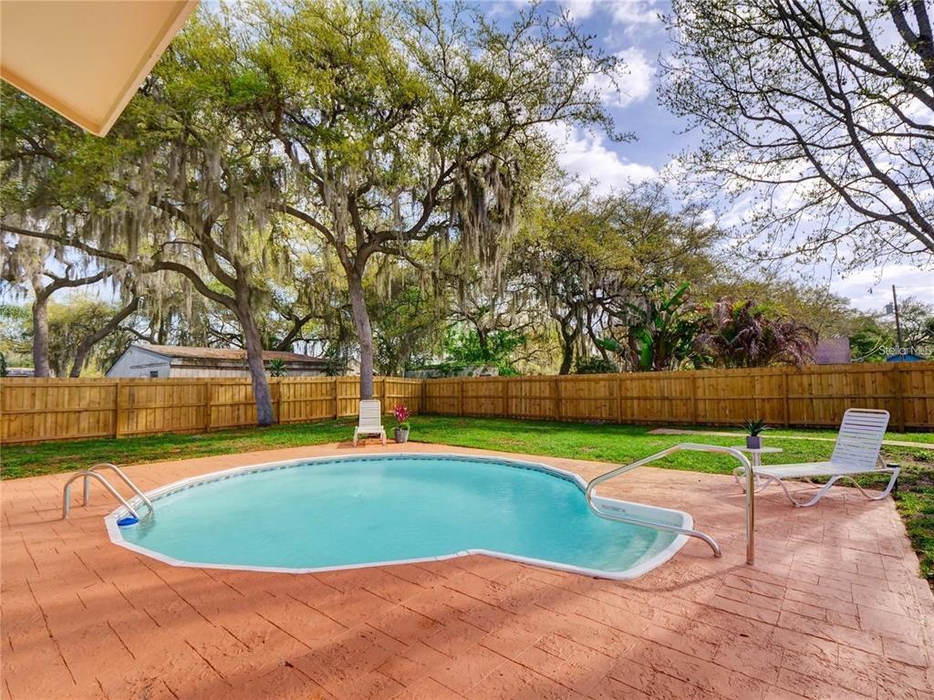 351 Monarco Avenue Deltona, FL 32725 - Photo 16 of 19 a view of a swimming pool with an outdoor space and seating area