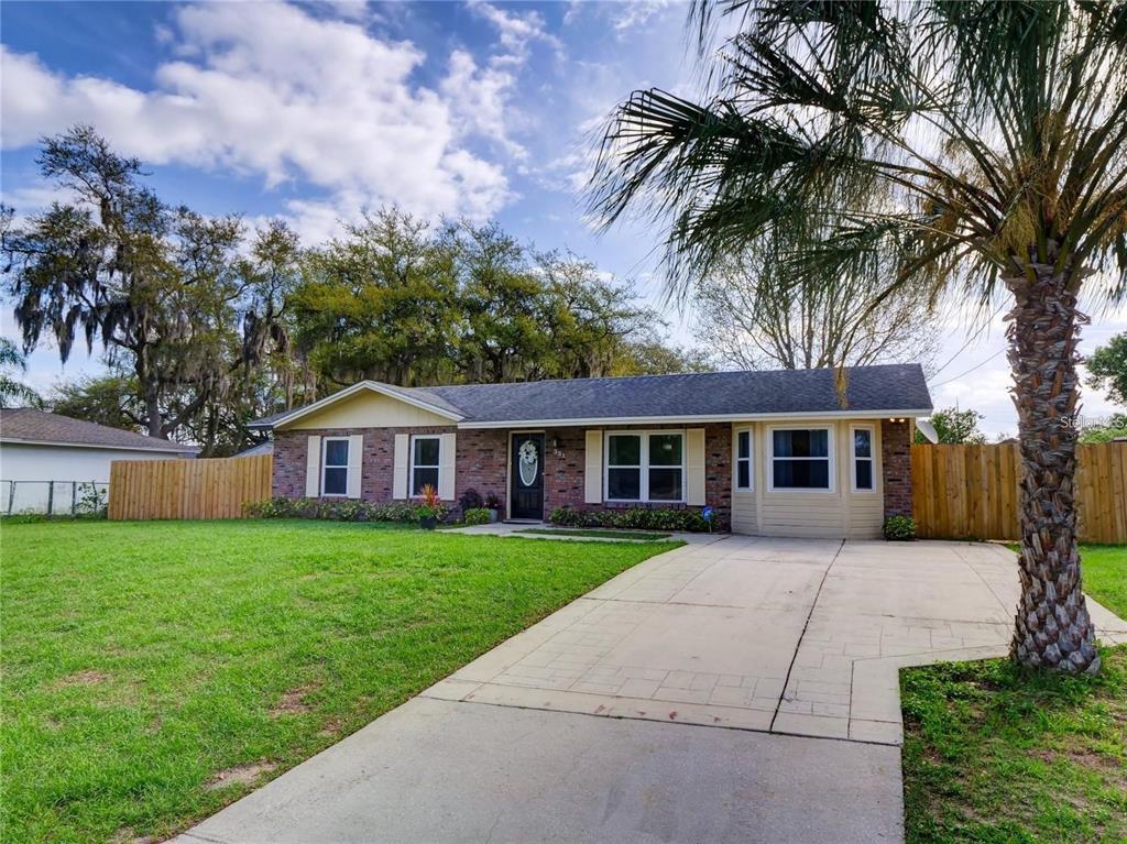 351 Monarco Avenue Deltona, FL 32725 - Photo 2 of 19 front view of a house with a garden
