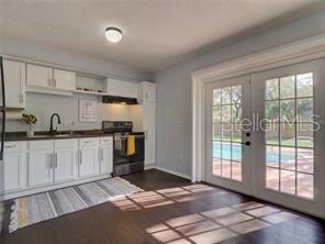 351 Monarco Avenue Deltona, FL 32725 - Photo 6 of 19 a kitchen with granite countertop a stove a sink and a refrigerator