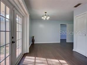 351 Monarco Avenue Deltona, FL 32725 - Photo 8 of 19 a view of a hallway with wooden floor and a bathroom
