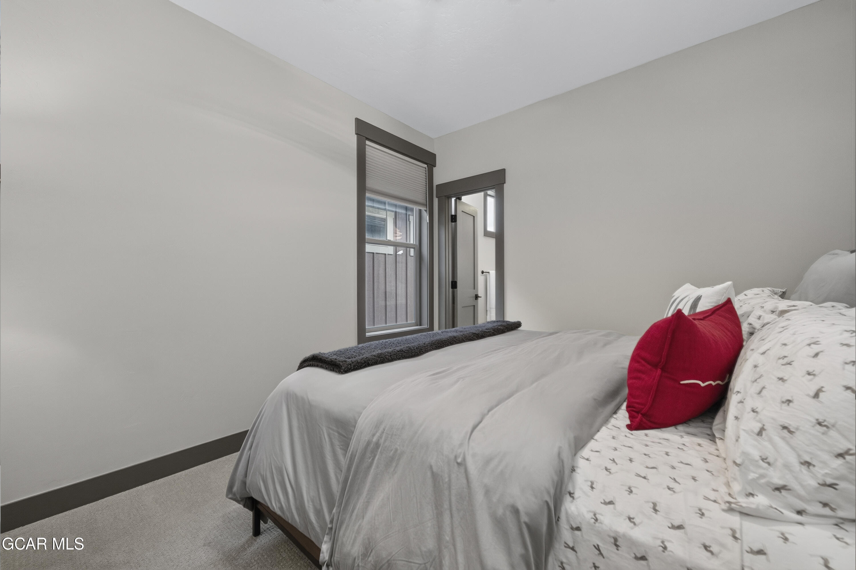 154 Eagle Ridge Drive Granby, CO 80446 - Photo 35 of 59 a bedroom with a bed and a window