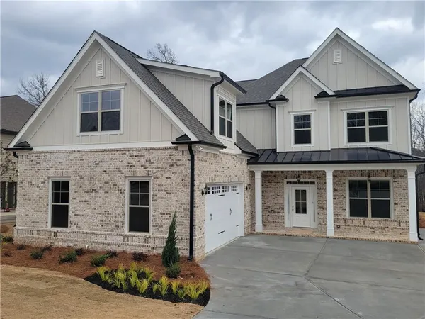 a front view of a house with large windows