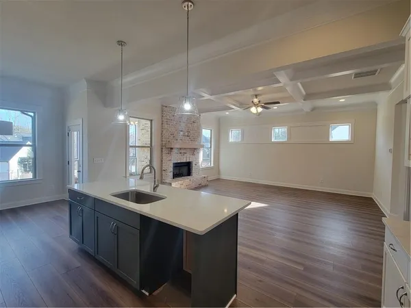 a kitchen with sink refrigerator and stove