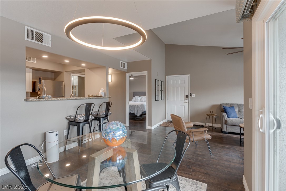 7255 West Sunset Road, Unit 2155 Las Vegas, NV 89113 - Photo 9 of 21 Dining space featuring dark wood-type flooring, high vaulted ceiling, and a ceiling fan