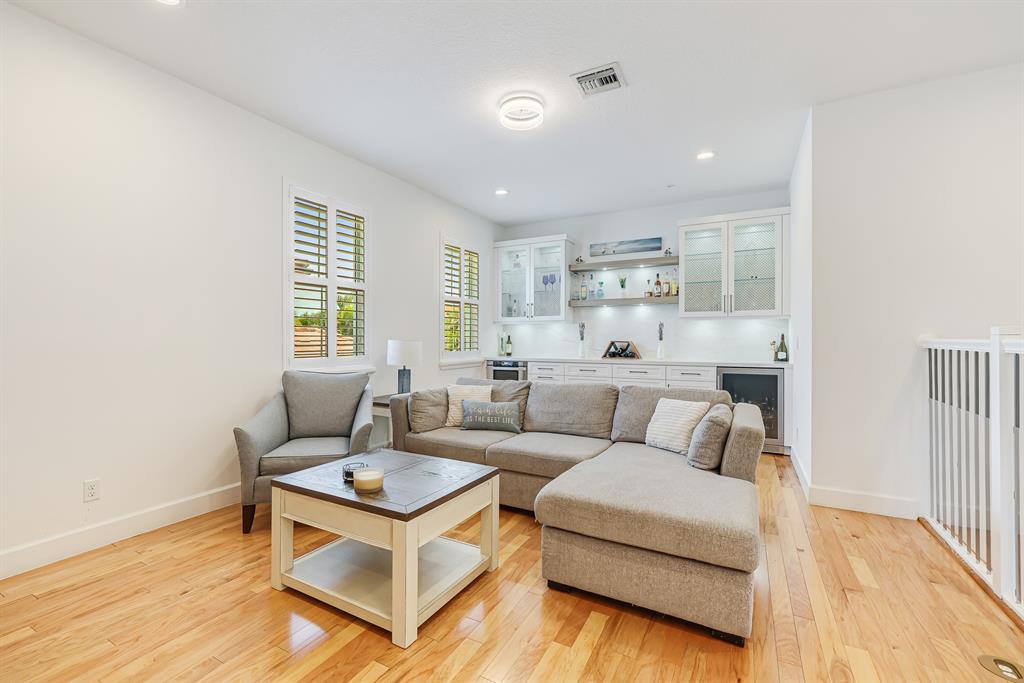 22954 Clear Echo Drive, Unit 31 Boca Raton, FL 33433 - Photo 26 of 44 a living room with furniture and a wooden floor