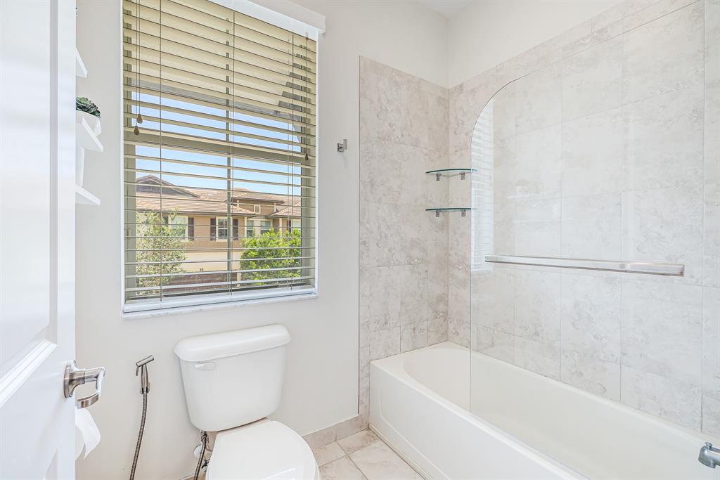 22954 Clear Echo Drive, Unit 31 Boca Raton, FL 33433 - Photo 33 of 44 a white toilet sitting next to a bath tub