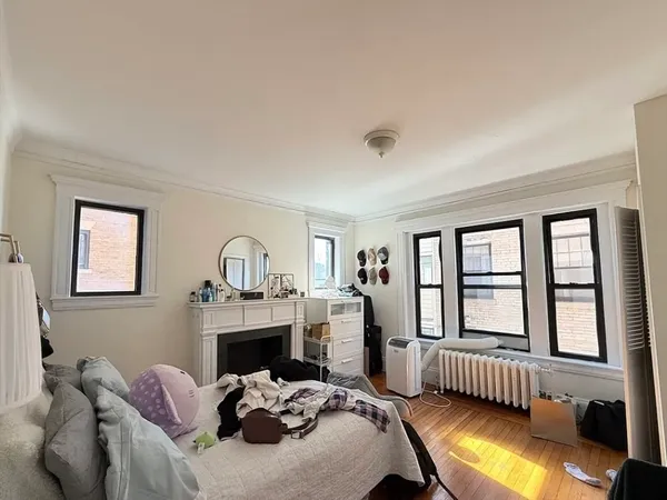 a bedroom with furniture and a fireplace
