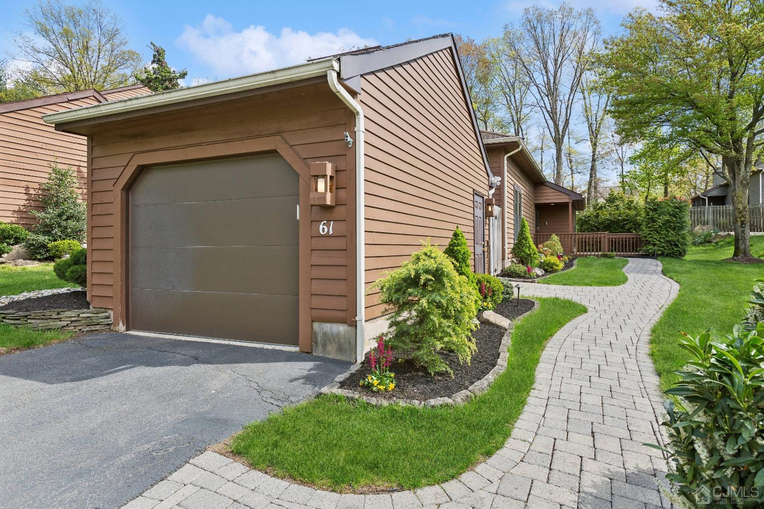 61 Giggleswick Way Edison, NJ 08820 - Photo 1 of 36 a front view of a house with a garden