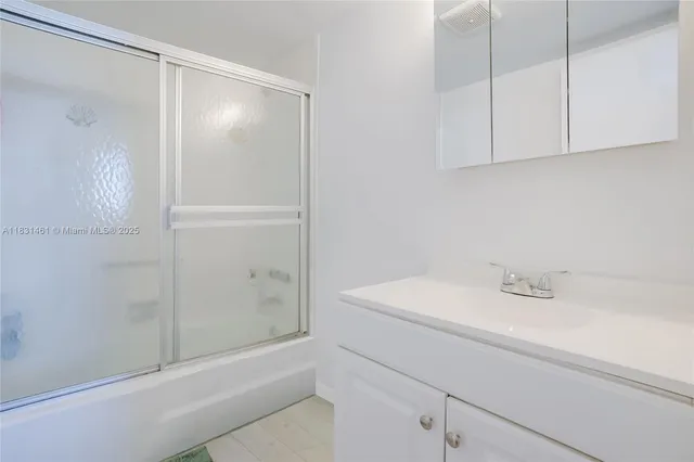 a bathroom with a shower and a sink