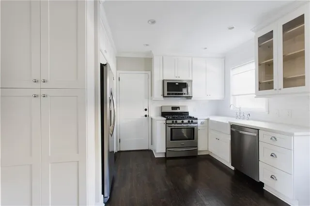 a kitchen with stainless steel appliances granite countertop a stove a sink and a refrigerator