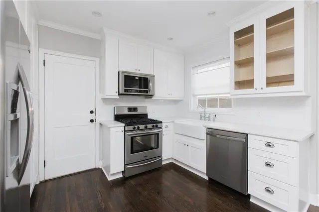 a kitchen with stainless steel appliances a stove microwave and refrigerator