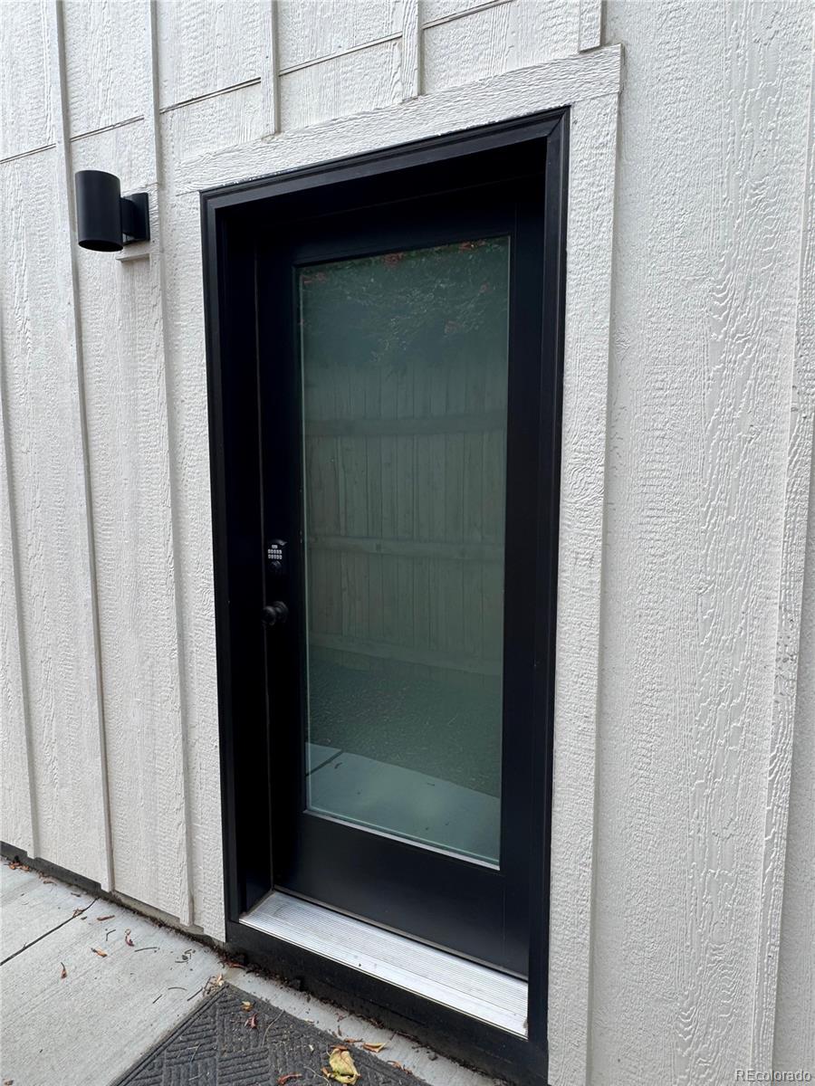 1310 Zenobia Street Denver, CO 80204 - Photo 3 of 9 a bathroom with a glass shower door