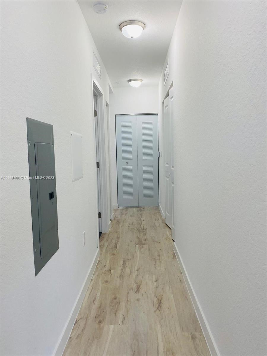 15520 Southwest 136th Street, Unit 106 Miami, FL 33196 - Photo 6 of 11 a view of hallway with wooden floor