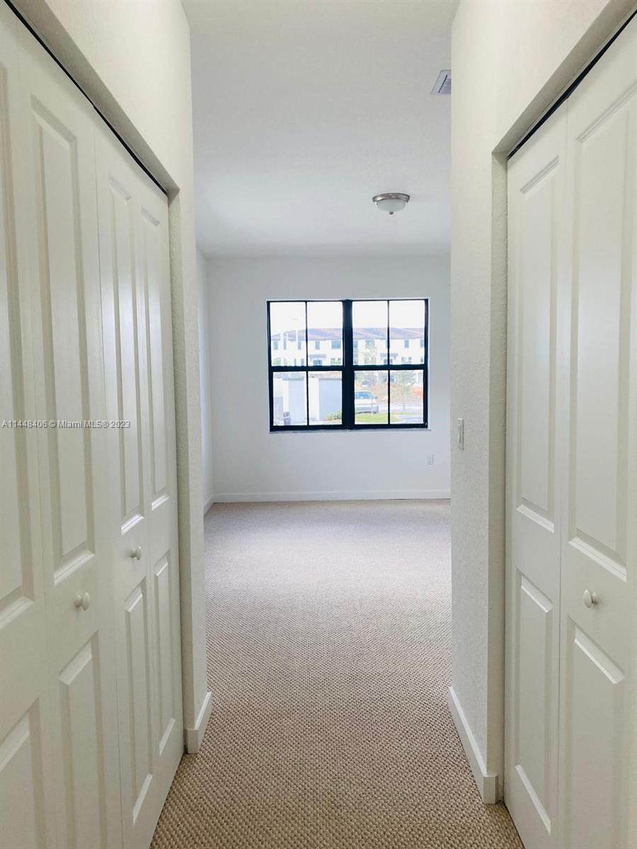 15520 Southwest 136th Street, Unit 106 Miami, FL 33196 - Photo 9 of 11 an empty room with windows