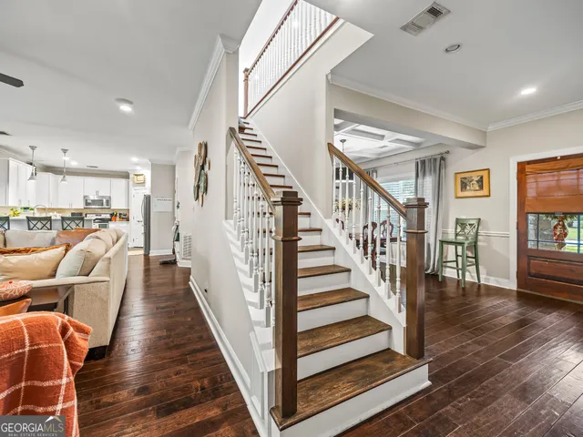a view of entryway and hall with wooden floor
