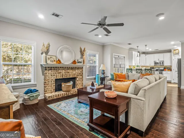 a living room with furniture fireplace and window