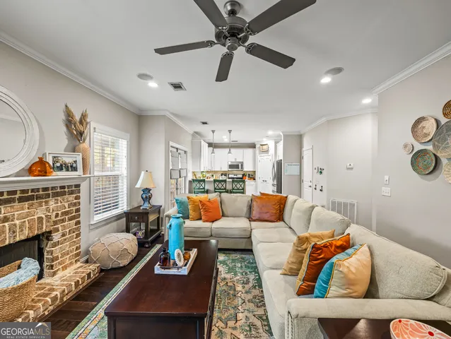 a living room with furniture a rug and a fireplace