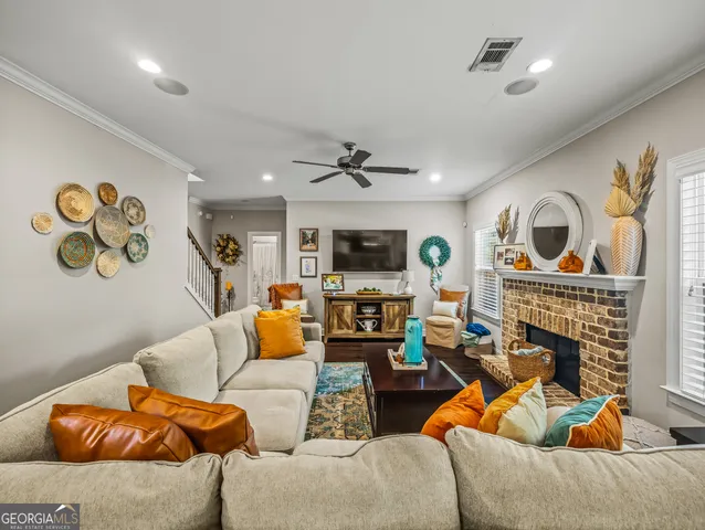 a living room with fireplace furniture and a wooden floor