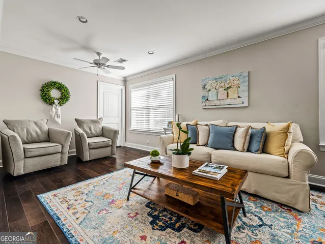 a living room with furniture and a rug