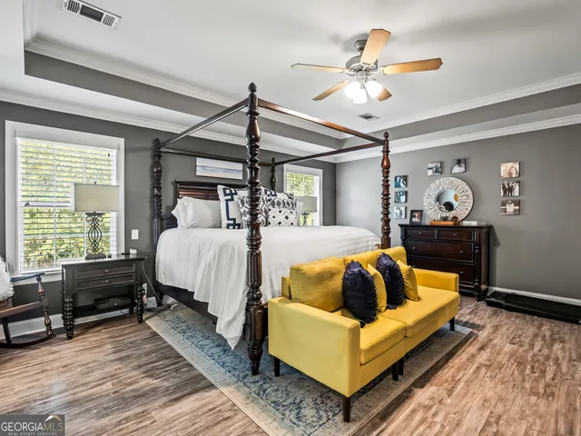 a bed room with couch and windows