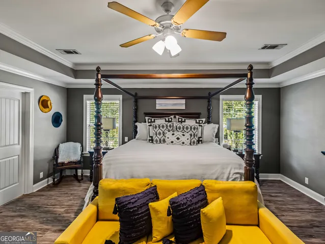 a spacious en suite bathroom with a sink a toilet and a mirror