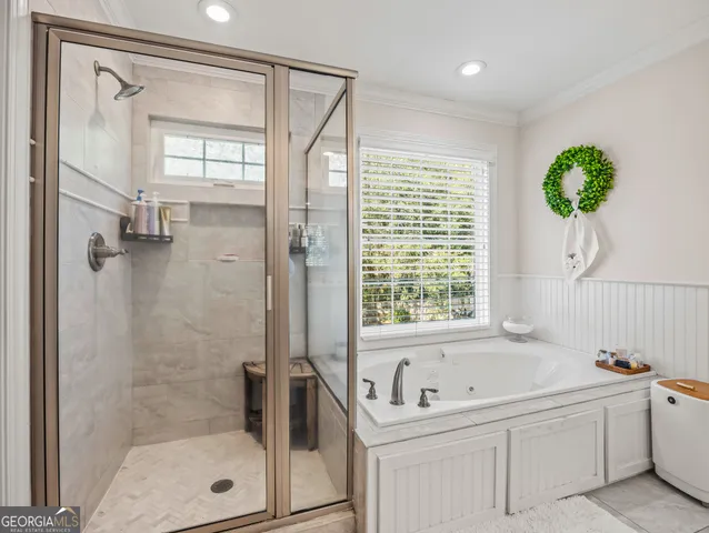 a spacious bathroom with a tub sink and mirror