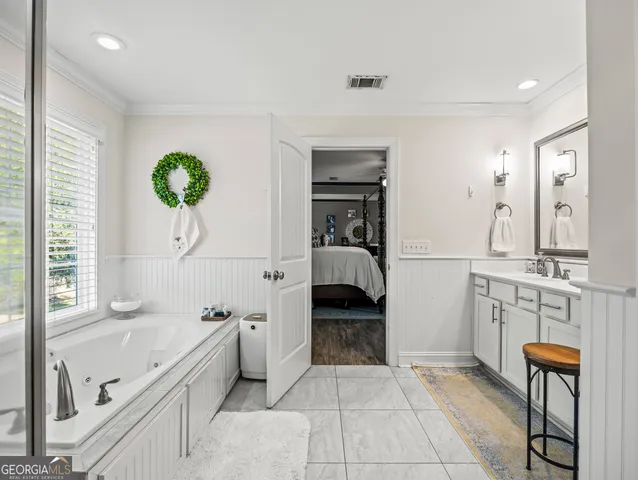 a living room with patio furniture and a large window