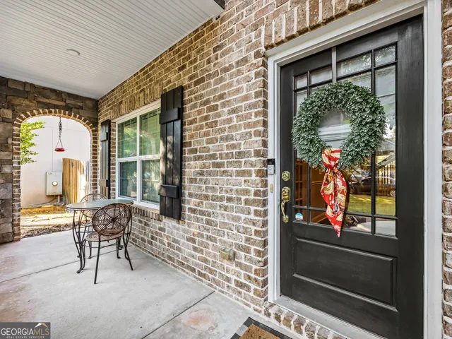 a building outdoor space with patio furniture and potted plants