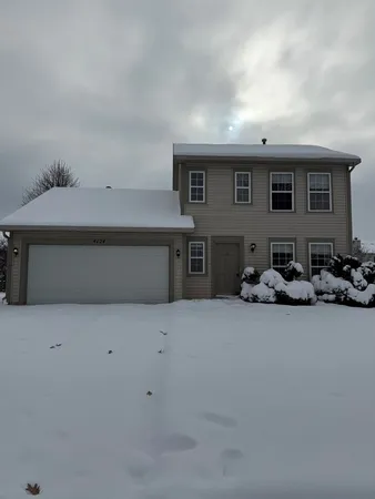 a view of a house with a car parked in it