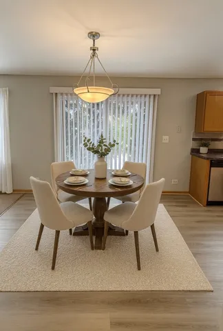 a view of a dining room with furniture window and wooden floor