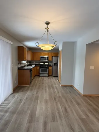 a kitchen with stainless steel appliances granite countertop a stove and a refrigerator