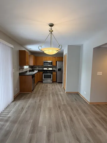 a kitchen with stainless steel appliances granite countertop a stove and a refrigerator