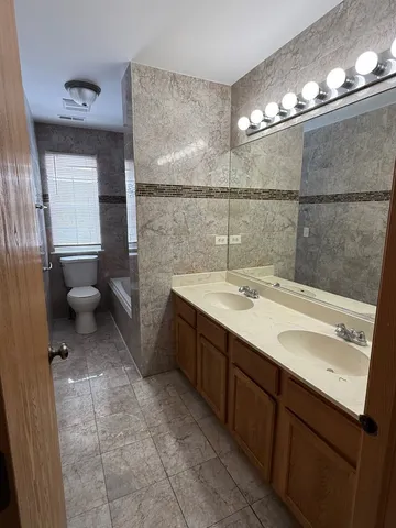 a bathroom with a sink double vanity and a mirror