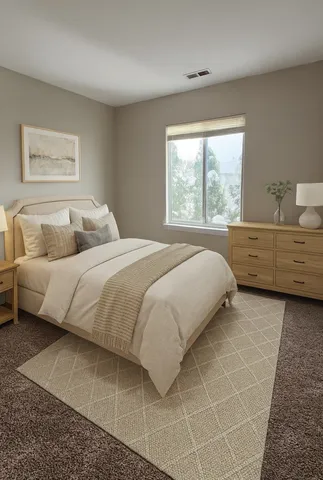 a bedroom with a bed and window