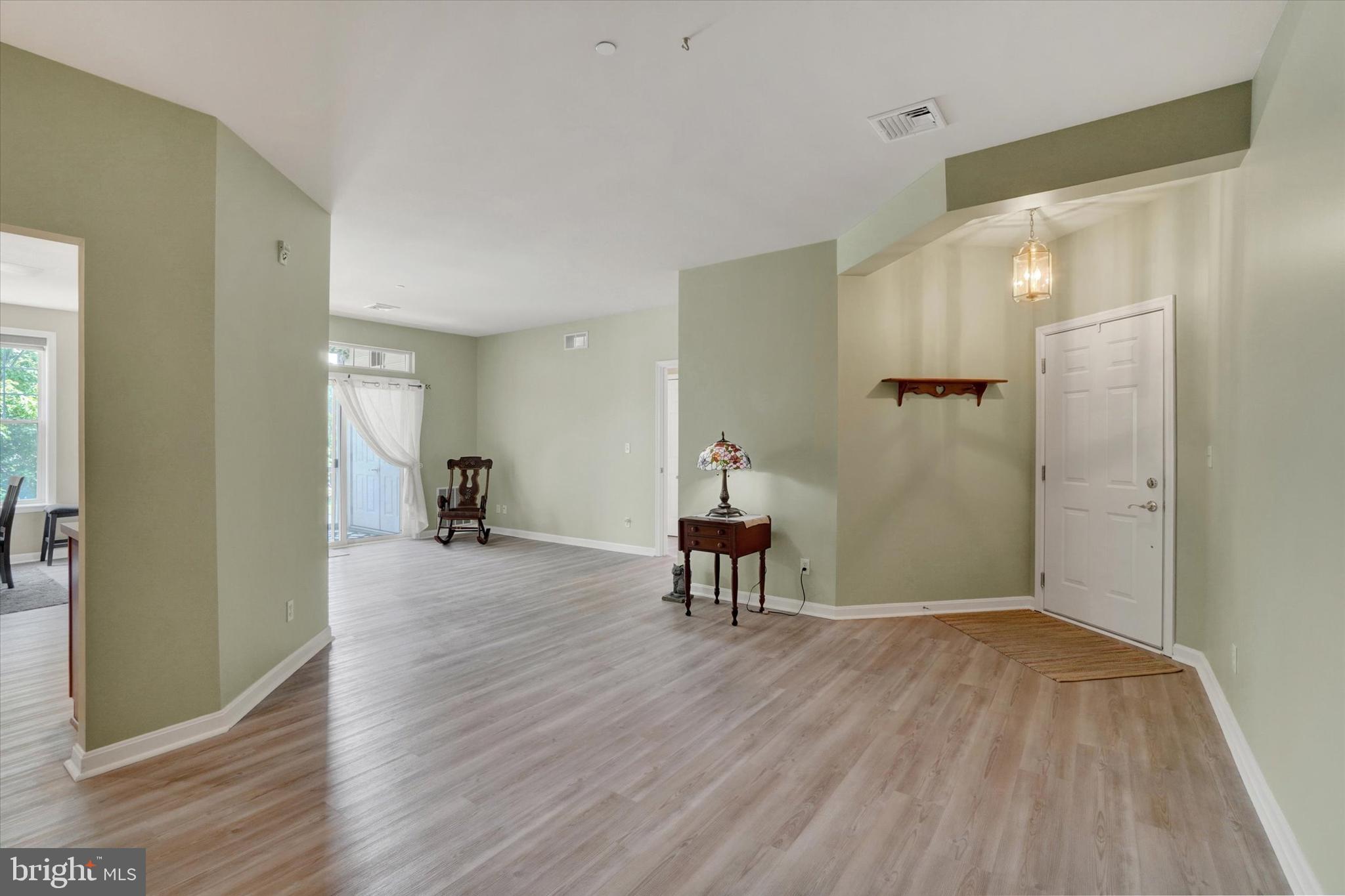 1010 Crest Way, Unit 304 York, PA 17403 - Photo 16 of 24 a view of a room with wooden floor table and chairs