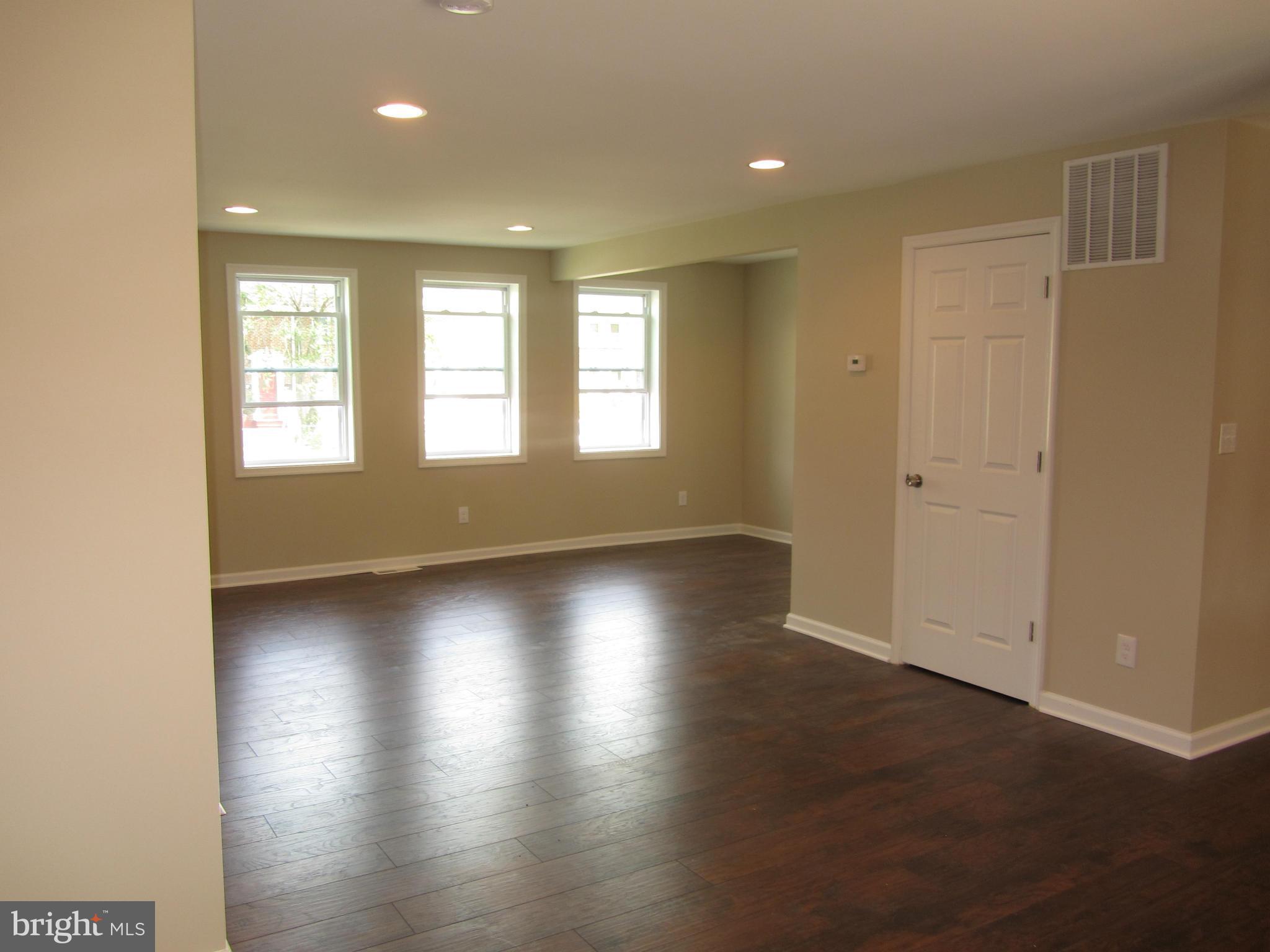 1645 Northgate Road Baltimore, MD 21218 - Photo 1 of 23 an empty room with wooden floor and windows