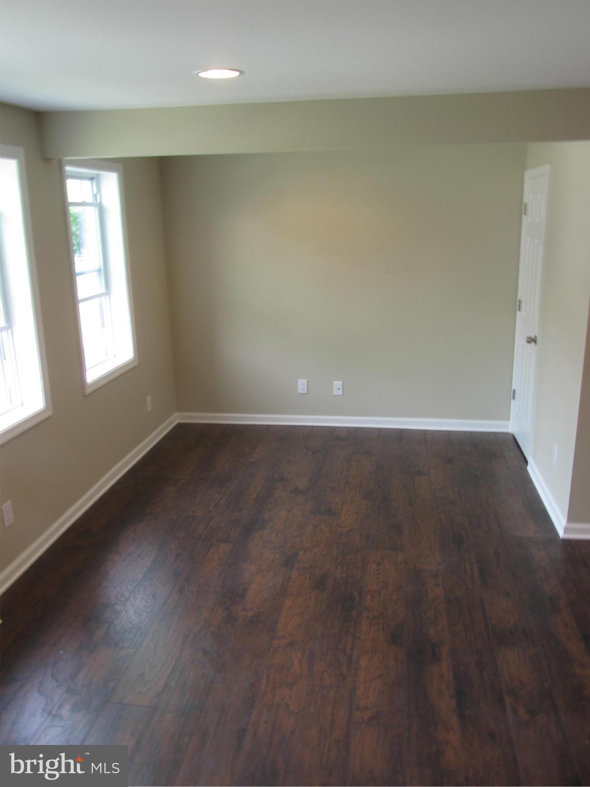 1645 Northgate Road Baltimore, MD 21218 - Photo 13 of 23 an empty room with wooden floor and windows