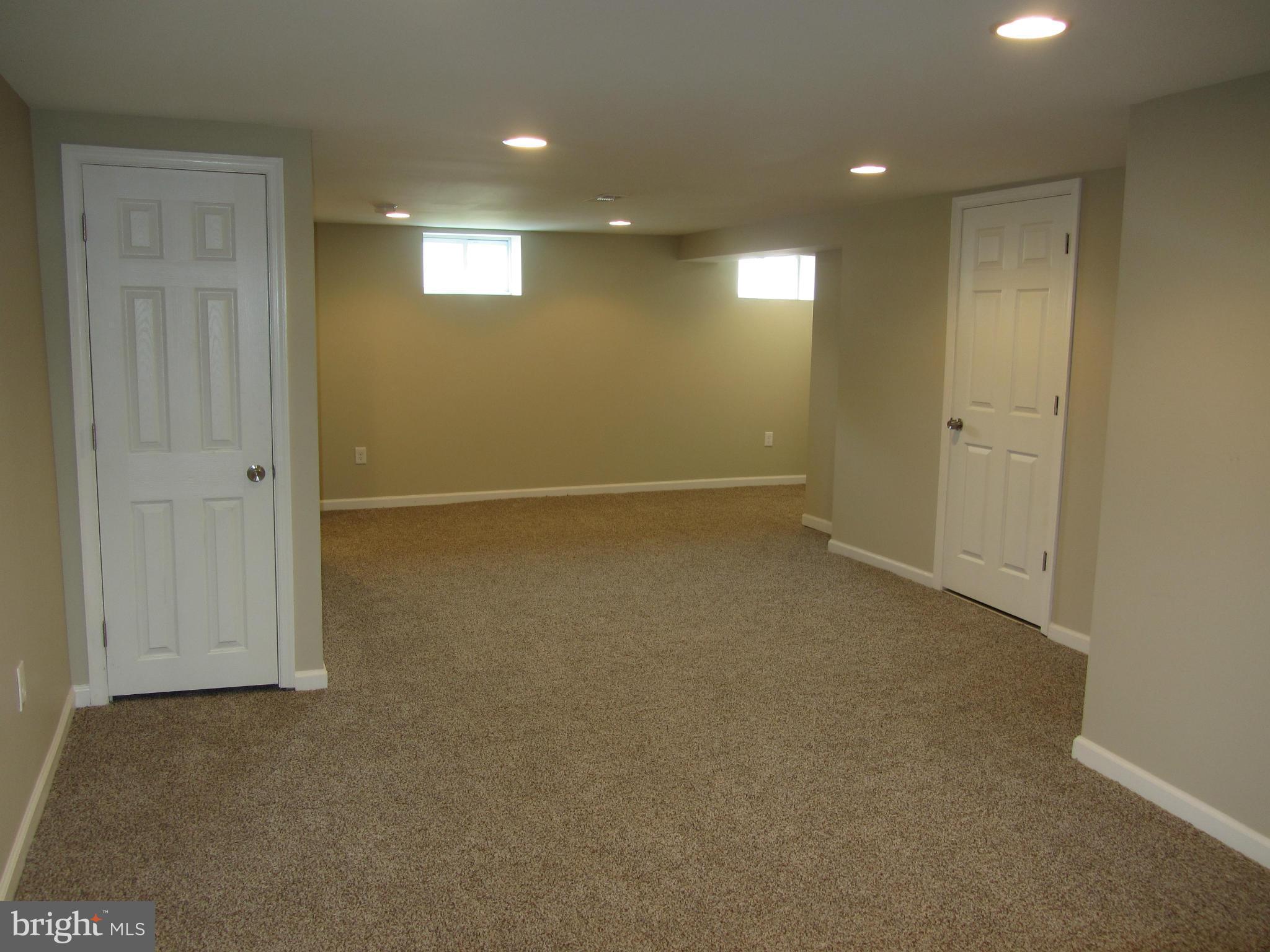 1645 Northgate Road Baltimore, MD 21218 - Photo 3 of 23 an empty room with windows and entrance to other room