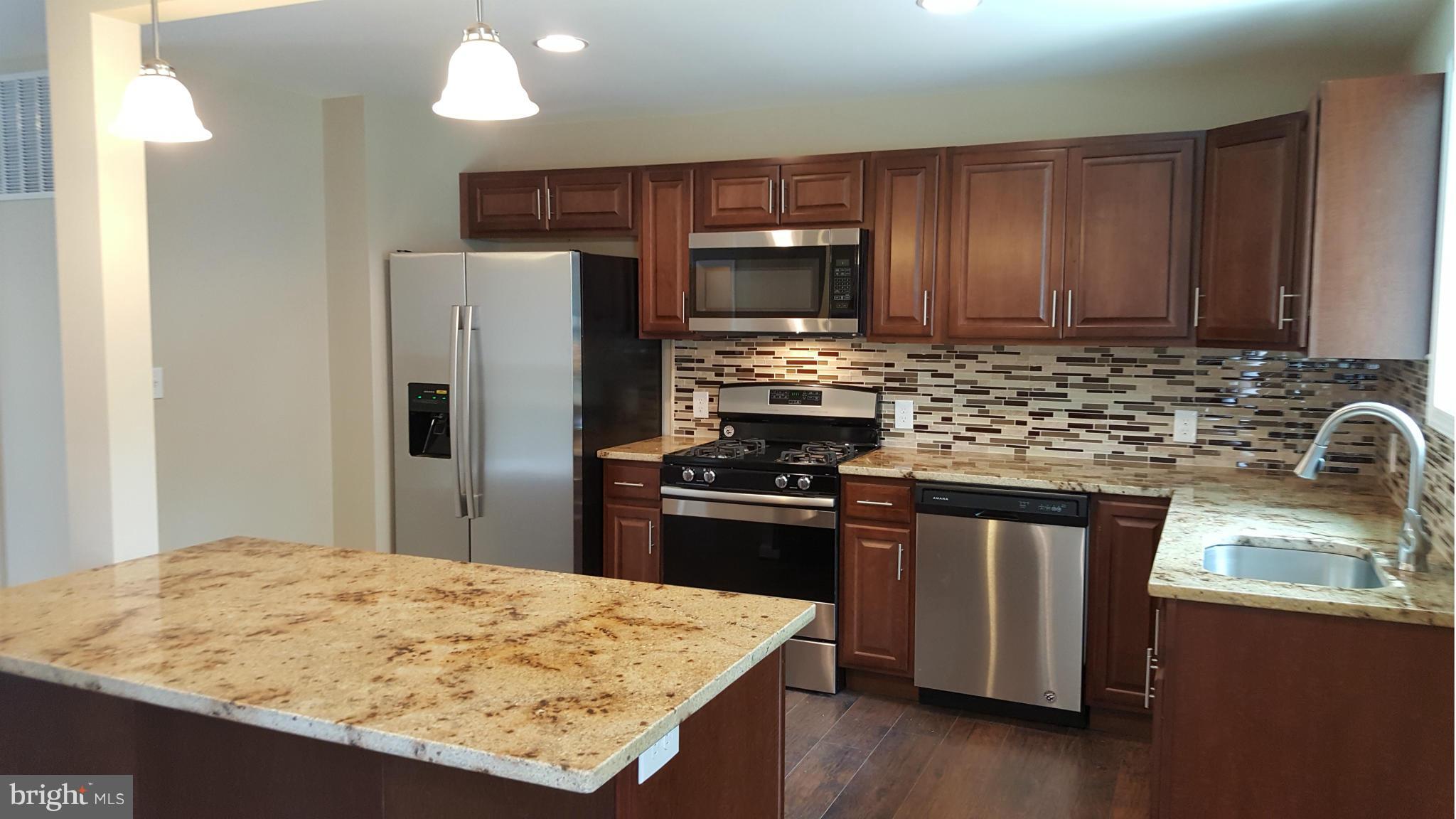 1645 Northgate Road Baltimore, MD 21218 - Photo 21 of 23 a kitchen with stainless steel appliances granite countertop a sink stove refrigerator and cabinets