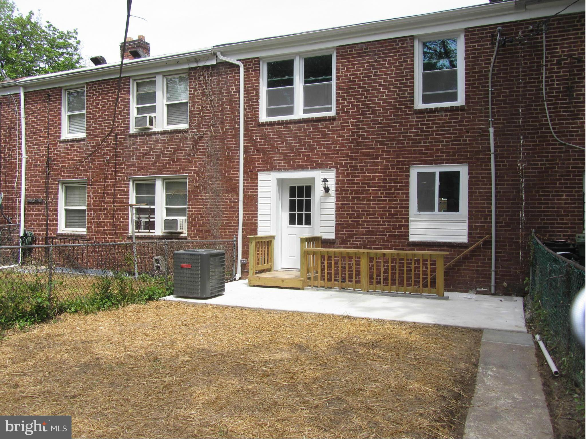 1645 Northgate Road Baltimore, MD 21218 - Photo 7 of 23 a front view of a house with a yard