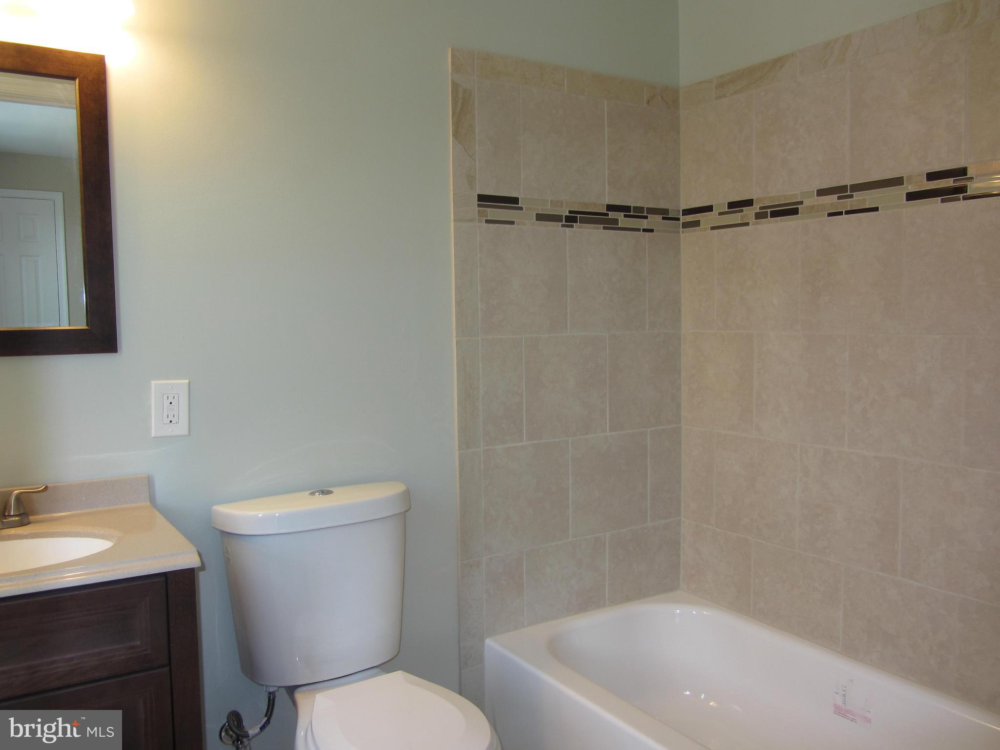 1645 Northgate Road Baltimore, MD 21218 - Photo 8 of 23 a white toilet sitting next to a bath tub