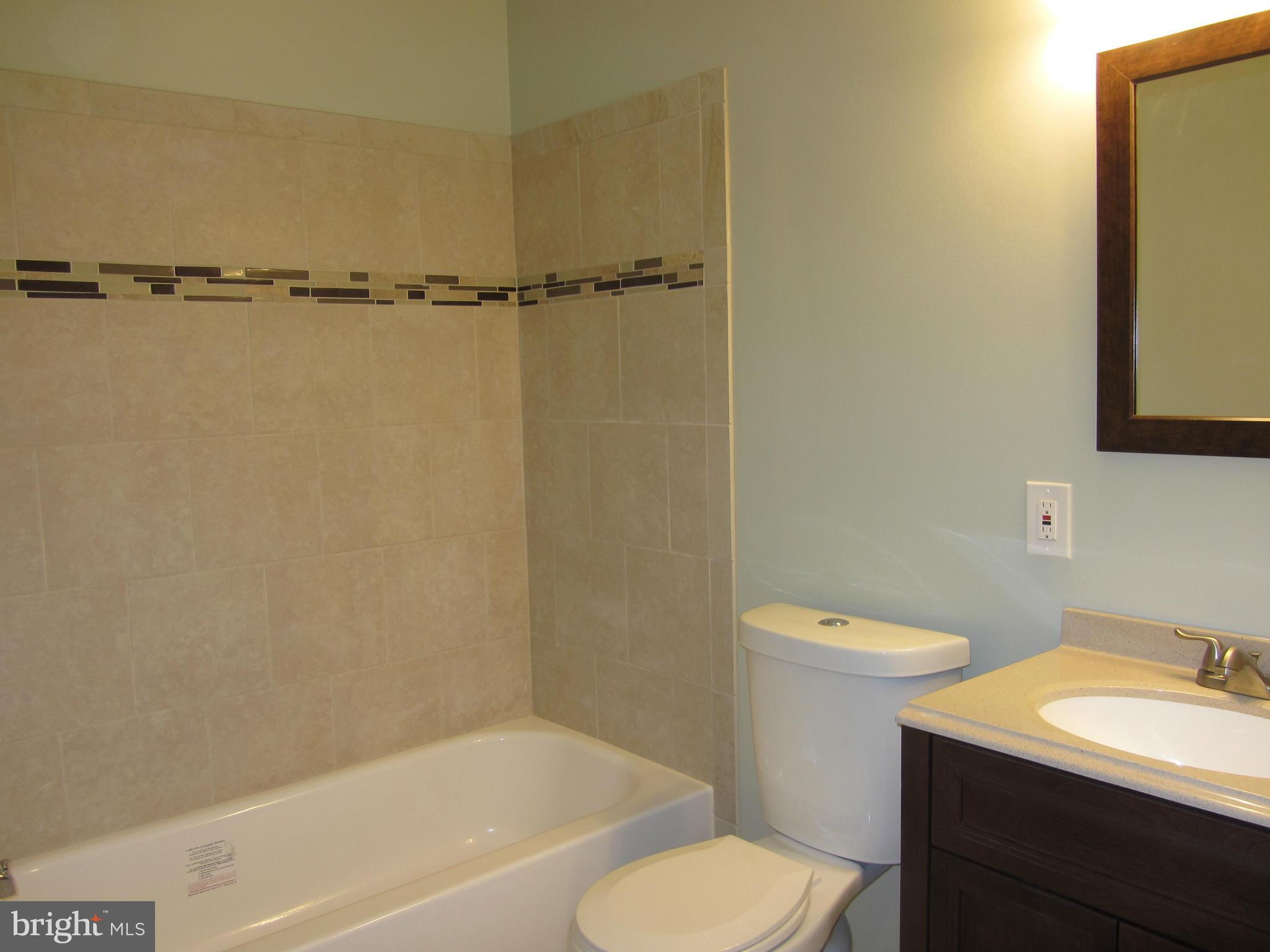 1645 Northgate Road Baltimore, MD 21218 - Photo 10 of 23 a bathroom with a toilet a sink and bathtub