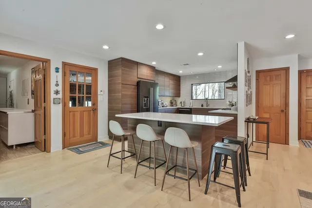 a kitchen with kitchen island granite countertop wooden cabinets and counter space