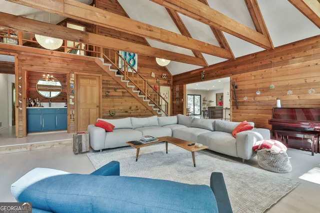 a living room with furniture and a ceiling fan