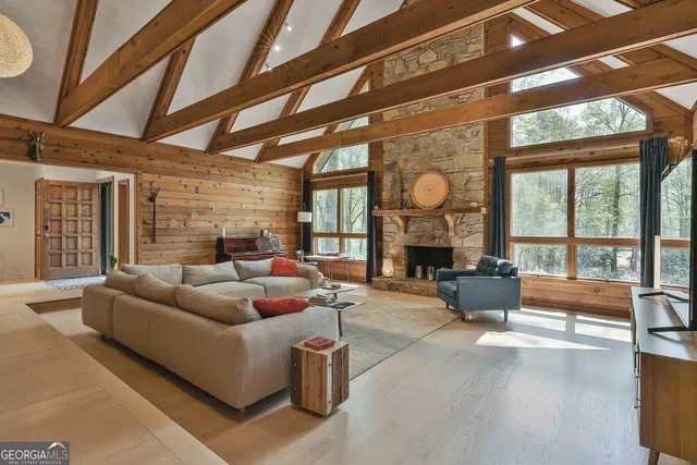 a living room with furniture a fireplace and a large window