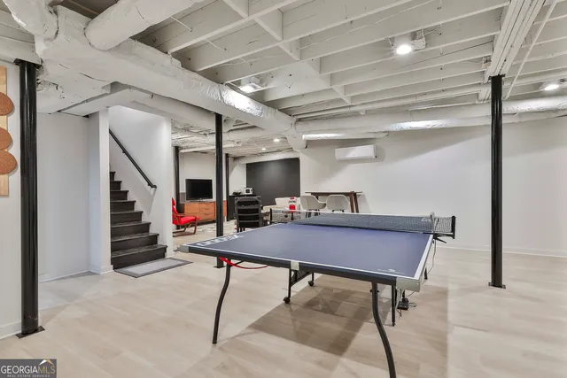 a projector room with a couch and a flat screen tv