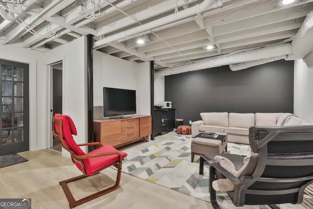 a living room with furniture and wooden floor